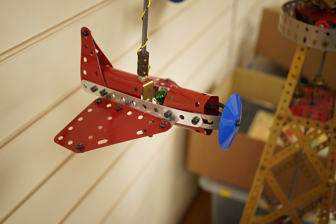 A Meccano model of a fairground ride, incorporating an electric motor in the base and lighting throughout, built in the style of a shop display centrepiece, approx 106cm high, 85cm diameter